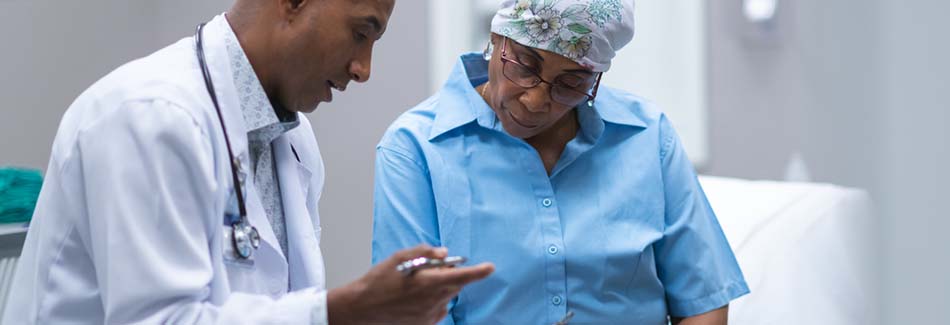 A patient meets with a doctor for a consultation at Baptist’s cancer treatment center