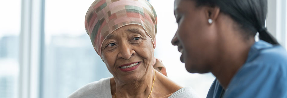 A senior woman meets with a nurse on the surgical oncology unit at Baptist Cancer Center